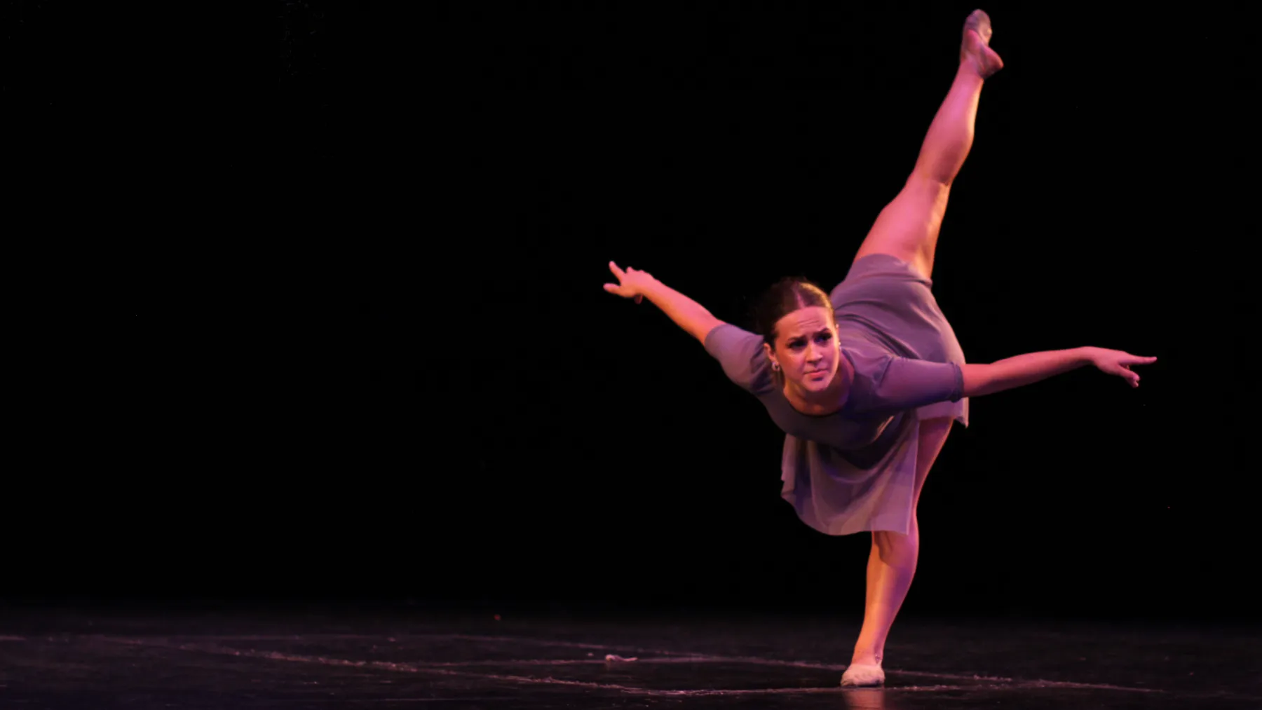 Dancer performing a dramatic extension on stage